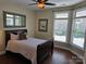 Cozy bedroom with dark wood furniture, large windows, and a tranquil ambiance at 1112 Avalon Pl, Stallings, NC 28104