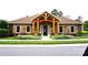 Exterior of the community clubhouse, featuring stone veneer and a covered porch at 1112 Avalon Pl, Stallings, NC 28104