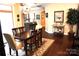 Elegant dining room featuring a chandelier, hardwood floors, stylish furnishings, and a bar cart at 1112 Avalon Pl, Stallings, NC 28104