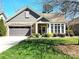 Charming home featuring stone accents, well-maintained landscaping, a driveway, and an attached two-car garage at 1112 Avalon Pl, Stallings, NC 28104