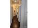 Hardwood hallway leading to various rooms, enhanced by recessed lighting and decorative niches at 1112 Avalon Pl, Stallings, NC 28104