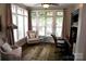 Bright home office with large windows, neutral colors, ceiling fan, and comfortable furnishings at 1112 Avalon Pl, Stallings, NC 28104