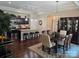 Stylish kitchen and dining area with stainless steel appliances, an island with bar seating, and elegant lighting fixtures at 1112 Avalon Pl, Stallings, NC 28104