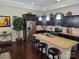 Bright kitchen boasts dark cabinets, stainless steel appliances, granite counters, and an island with seating at 1112 Avalon Pl, Stallings, NC 28104