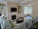 Cozy living room with a stone fireplace, built-in shelves, and comfortable seating, creating a warm and inviting atmosphere at 1112 Avalon Pl, Stallings, NC 28104