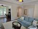 Spacious living room showcasing a view into the office, a cozy sofa, and stylish decor, creating a comfortable living space at 1112 Avalon Pl, Stallings, NC 28104
