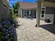 Beautifully landscaped patio with stone pavers, lush hydrangeas, and a cozy dining area, creating a serene outdoor space at 1112 Avalon Pl, Stallings, NC 28104