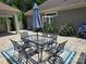 Inviting patio area featuring an outdoor dining set, umbrella, and colorful rug, ideal for relaxing and enjoying the outdoors at 1112 Avalon Pl, Stallings, NC 28104