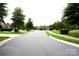 Community street view showcasing the road, greenery, and neighborhood buildings at 1112 Avalon Pl, Stallings, NC 28104