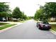 Neighborhood street view with tree-lined sidewalks and parked vehicles at 1112 Avalon Pl, Stallings, NC 28104