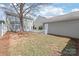 Backyard shot with picket fence, a detached garage, and an olive green exterior at 11122 Aprilia Ln, Cornelius, NC 28031