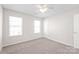 Neutral bedroom featuring two windows for natural light and a ceiling fan at 11122 Aprilia Ln, Cornelius, NC 28031