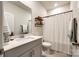 Clean bathroom with modern vanity, decorative shelves, and a shower with a curtain at 11810 Red Leaf Dr, Charlotte, NC 28215