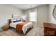 Cozy bedroom with carpet, natural light, and neutral colors creating a peaceful atmosphere at 11810 Red Leaf Dr, Charlotte, NC 28215