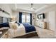 Serene main bedroom with tray ceiling, blue accents, and ample natural light at 11810 Red Leaf Dr, Charlotte, NC 28215