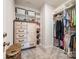 Well-organized walk-in closet with built-in shelving and drawers at 11810 Red Leaf Dr, Charlotte, NC 28215