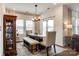 Charming dining area with elegant lighting, rustic wood table, and plenty of seating at 11810 Red Leaf Dr, Charlotte, NC 28215