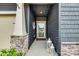 Welcoming front entrance with decorative lanterns and stone-accented pillars at 11810 Red Leaf Dr, Charlotte, NC 28215