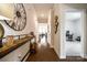 Elegant hallway featuring hardwood floors and decorative accents leading to office and living areas at 11810 Red Leaf Dr, Charlotte, NC 28215