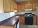 Well-lit kitchen features wood cabinetry, a stainless steel sink, and essential appliances at 120 24Th Street St, Hickory, NC 28601