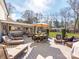 Deck featuring an outdoor dining area, lounge chairs, covered patio and backyard views at 12510 Pine Terrace Ct, Charlotte, NC 28273