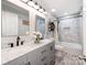 Modern bathroom featuring double sinks, marble countertops, updated fixtures and tile in shower at 12510 Pine Terrace Ct, Charlotte, NC 28273