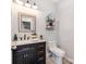 Chic half-bathroom featuring a marble vanity, elegant mirror, and modern fixtures at 12510 Pine Terrace Ct, Charlotte, NC 28273