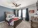 Comfortable bedroom showcasing a wooden bed frame, American flag decor, and a ceiling fan at 12510 Pine Terrace Ct, Charlotte, NC 28273