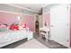 Charming bedroom featuring pink accent wall, plush toys, and a vanity with a matching stool at 12510 Pine Terrace Ct, Charlotte, NC 28273