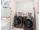 Functional laundry room with modern washer and dryer units and ample storage shelves at 12510 Pine Terrace Ct, Charlotte, NC 28273