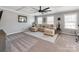 Inviting living room featuring a cozy sectional sofa and abundant natural light at 12510 Pine Terrace Ct, Charlotte, NC 28273