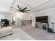 Bright living room featuring a decorative ceiling, fan, television, and stairway to the second level at 12510 Pine Terrace Ct, Charlotte, NC 28273