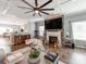 Open-concept living room featuring hardwood floors, coffered ceiling, and natural light at 12510 Pine Terrace Ct, Charlotte, NC 28273