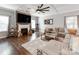 Inviting living room featuring a stone fireplace, coffered ceiling, and modern decor at 12510 Pine Terrace Ct, Charlotte, NC 28273