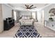 Spacious main bedroom with a sitting area, ceiling fan, neutral colors, and decorative rug at 12510 Pine Terrace Ct, Charlotte, NC 28273