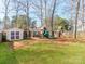 Backyard with playground equipment, shed, and partially fenced yard at 12510 Pine Terrace Ct, Charlotte, NC 28273