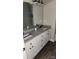 Bathroom featuring double sinks with granite counters, a large mirror, and white cabinets at 1303 W Gold Street Ext, Kings Mountain, NC 28086