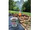 Backyard featuring a fire pit, a beautiful rock surround, and nice landscaping at 1308 Moonshadow Ln, Shelby, NC 28150