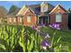 Beautiful brick home with manicured front yard and vibrant flowers in foreground at 1308 Moonshadow Ln, Shelby, NC 28150