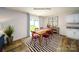 Bright dining room with red chairs, wood table, and striped rug with access to the backyard at 1314 37Th Avenue Ne Ln, Hickory, NC 28601