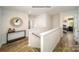 Upstairs hallway featuring a console table with vases and views into bedrooms at 1314 37Th Avenue Ne Ln, Hickory, NC 28601