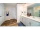 Bathroom features a double sink vanity, a large mirror, and wood-look flooring at 1443 Mammoth Rd, Hickory, NC 28602