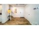 Bright foyer with wood-look floors, coat rack, and staircase leading to the upper level at 1443 Mammoth Rd, Hickory, NC 28602