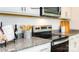 Close-up of a modern kitchen with granite countertops and stainless steel appliances at 1443 Mammoth Rd, Hickory, NC 28602