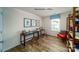 Office featuring two black desks, a window seat, and wood-look floors at 1443 Mammoth Rd, Hickory, NC 28602