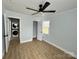 Bedroom with view to laundry and closet. Features wood-look flooring, and a ceiling fan at 1946 Academy St, Charlotte, NC 28205