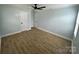 Bright bedroom features wood-look flooring, light blue walls, and a black ceiling fan at 1946 Academy St, Charlotte, NC 28205