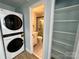 Functional hallway area with a washer and dryer set, leading to an updated bathroom and convenient storage shelving at 1946 Academy St, Charlotte, NC 28205