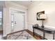 Bright foyer featuring hardwood floors, elegant console table, and stylish mirror at 2110 Capricorn Ave, Indian Trail, NC 28079