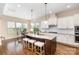 Bright kitchen with large center island, granite counters, pendant lights, and eating area at 2110 Capricorn Ave, Indian Trail, NC 28079